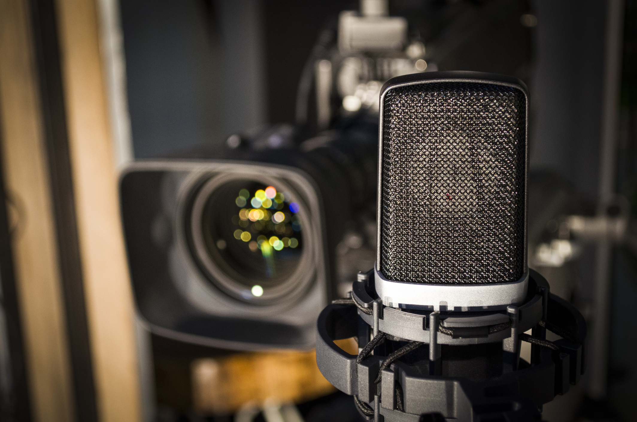 Retro microphone on stage with a background of a studio camera