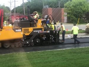 Large machine laying asphalt for the new parking lot